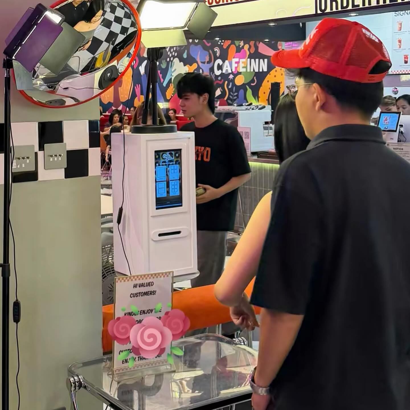 Customers using the Click2Keep booth at Cafe Inn